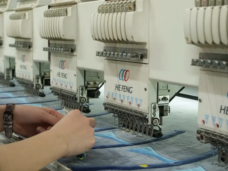 Multi-head embroidery machines stitching details for custom plush panels