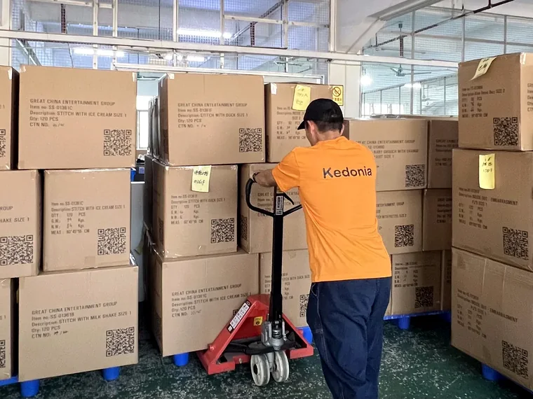 Factory logistics worker handling packed cartons for custom plush export shipping