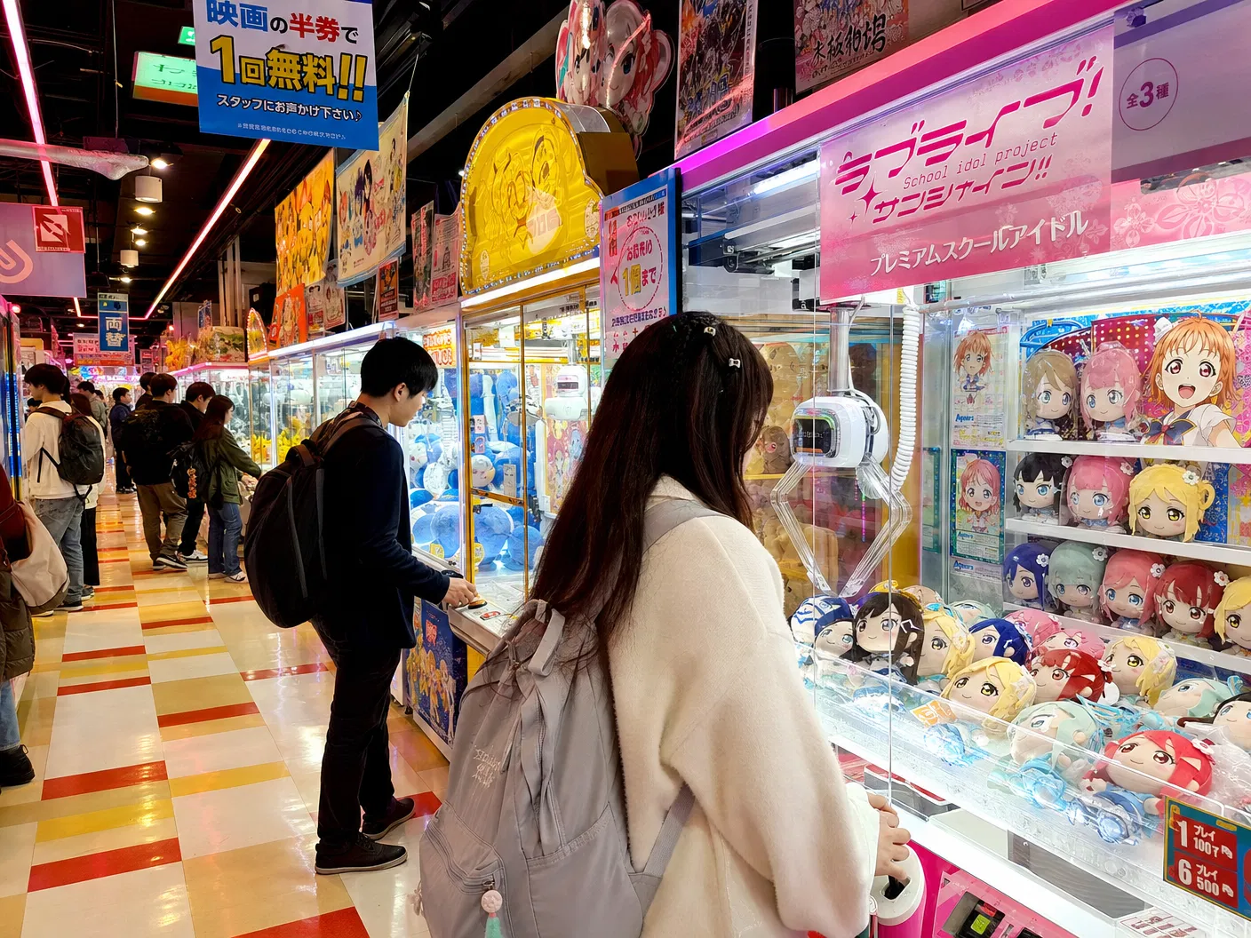 Japanese UFO Catcher arcade in Tokyo with rows of claw machines filled with anime plush