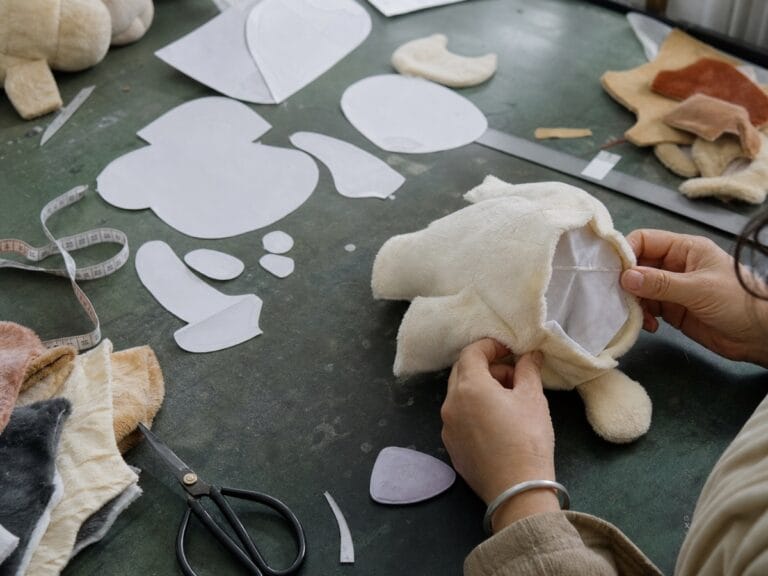 Plush toy pattern making workbench with prototype shell and fabric pieces