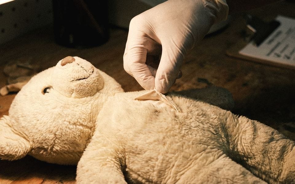 Final QC inspection station checking plush stitching and safety details