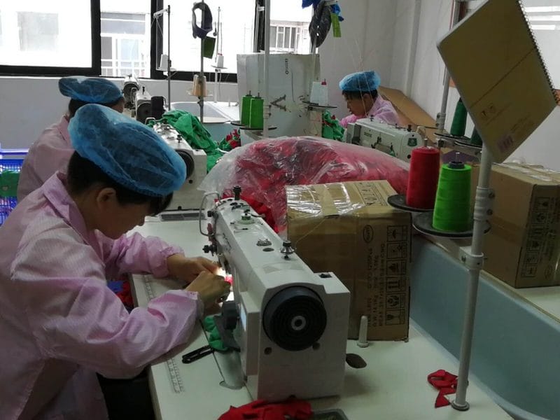 Custom plush sewing line with operators and sewing machines
